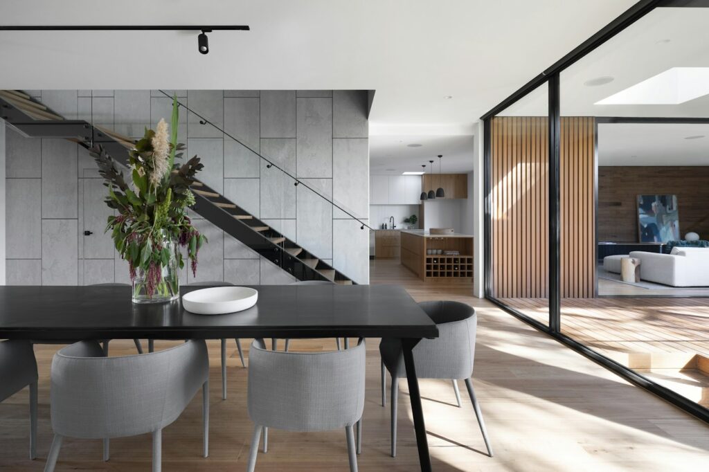 Architectural flow between living, dining, and kitchen spaces